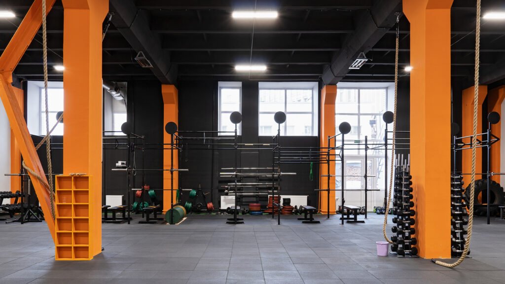 Spacious modern interior of the gym for fitness training with horizontal bar and rope